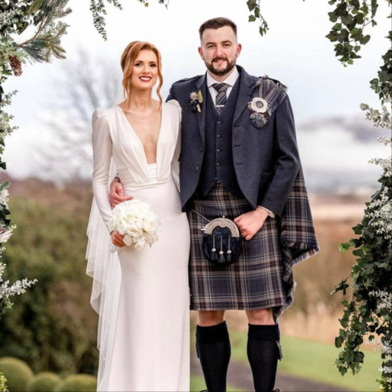 Bride with wedding flowers by Thistle Du Florist