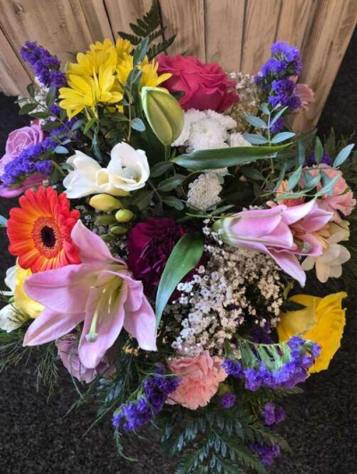 Colour Symphony Vase - A vibrant vase arrangement bursting with rich pinks, purples, yellows and oranges, creating a bold and beautifully eclectic display.