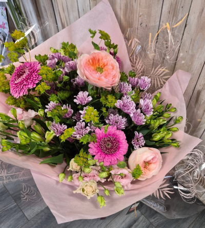 Sweet Peaches - A pretty bouquet blending soft peach and pink tones with delicate purples and vibrant green accents for a fresh, romantic finish.