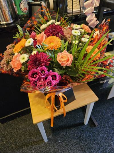 Autumn Glow - A vibrant bouquet in rich orange, peach and berry shades, full of seasonal warmth.
