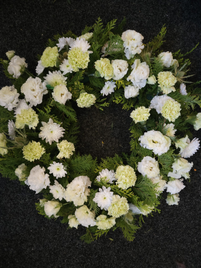 Peaceful White Wreath - A classic white wreath representing peace, remembrance and everlasting love.