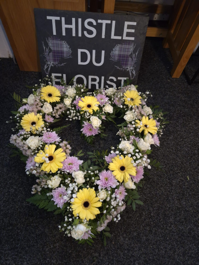 Sunlit Memories Wreath - A beautiful open wreath in gentle yellow, lilac and white shades to honour a treasured life.