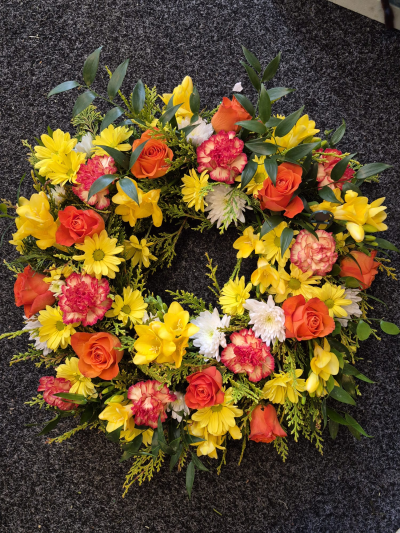 Autumn Memories Wreath - A warm and uplifting wreath in orange and yellow tones, created as a loving tribute.