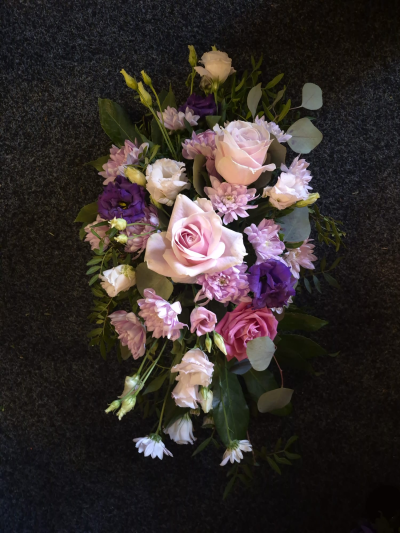 Gentle Lilac Spray - A graceful funeral spray in soft pink and lilac shades, perfect for a heartfelt farewell.